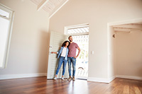 Happy couple walking into their newly built home designed by the best NJ home builder