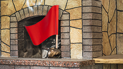 Fireplace with a red flag in it asking for a chimney cleaning in Ocean County
