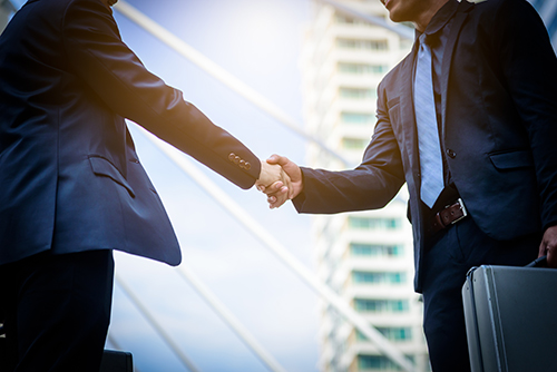Branch manager shaking hands with NJ NCR dealer in NJ